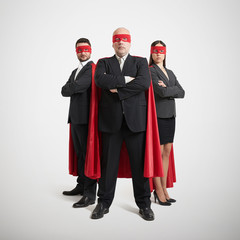 three superheroes in formal wear