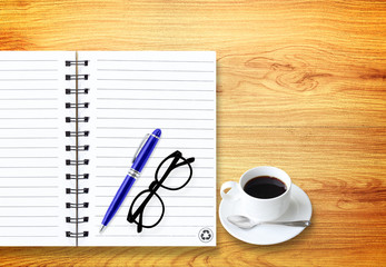Notebook with office supplies with pen with glasses and cup of c