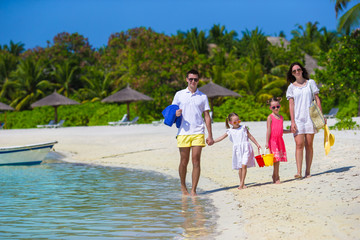 Happy family during summer vacation on white beach
