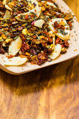 Colored spices for pasta mix on wooden spoon