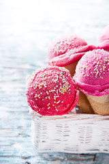 Ice cream scoops on wooden table.