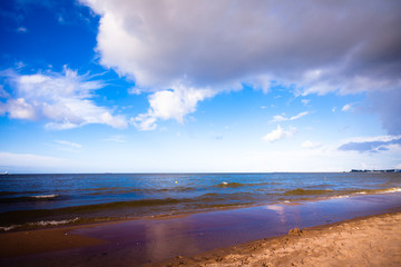 View of cloudy sky at sea with footprints on a beach