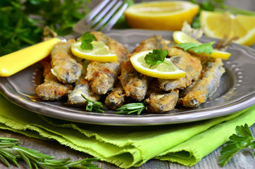Fried capelin with lemon and herbs.