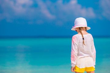 Adorable little girl at beach during summer vacation