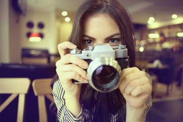 young girl with a vintage camera