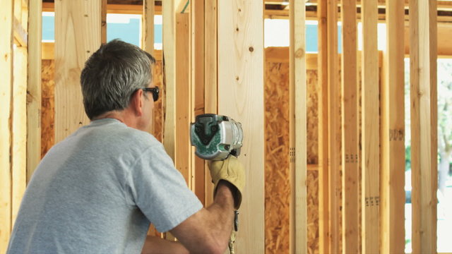 builder with a nail gun