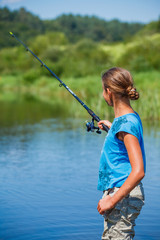 Girl fishing on the river.
