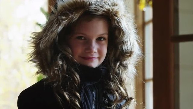 CU Portrait of smiling girl (8-9) wearing warm jacket with fur hood / Cedar Hills, Utah, USA