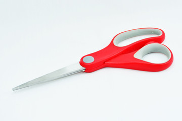 Red scissors isolated white background.