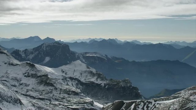 Wide shot/time lapse of snow covered mountain / Schilthorn Piz Gloria, Bern, Switzerland