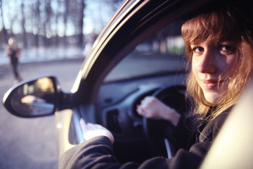 Fototapeta na wymiar portrait of a girl in a car driver at the wheel