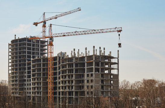 Image of building under construction and cranes