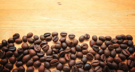 Coffee beans on wood background