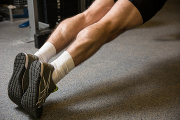 Fitness trained beautiful legs in sneakers.