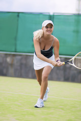 Professional Female Tennis Player in Action On Court.