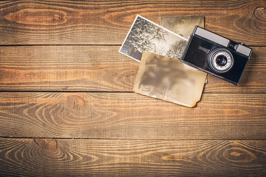 Instagram. Top view of old vintage camera and pictures over
