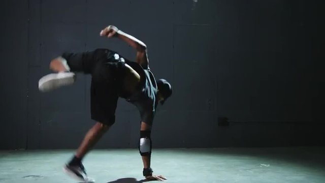 WS Studio shot of young man breakdancing