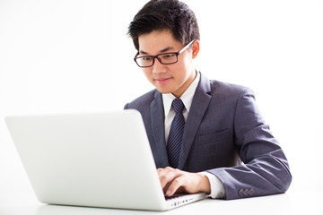 Handsome businessman working with laptop