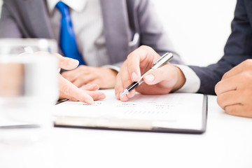Two businessmen looking at report and having a discussion in off