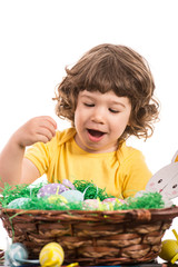 Amazed toddler choose Easter egg
