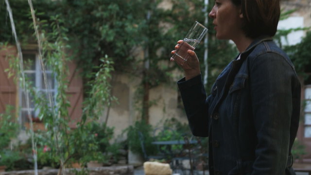 Woman Drinking From A Fountain