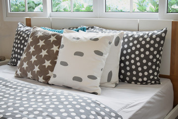 bedroom interior design with polka dot pillows on bed and decora