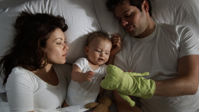 couple and baby in bed
