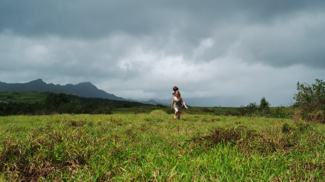 two children running through a field