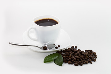 coffee in white cup and coffee beans