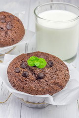 Delicious chocolate muffins with choco chips and glass of milk
