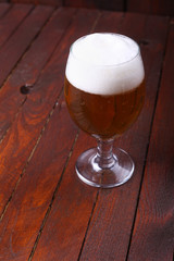 Glass of beer on wood
