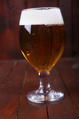 Glass of beer on wood