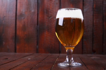 Glass of beer on wood