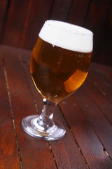 Glass of beer on wood