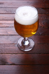 Glass of beer on wood