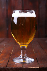 Glass of beer on wood