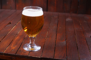 Glass of beer on wood