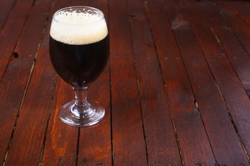 Dark beer on wood