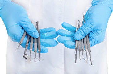 hands holding dental instruments