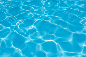 Fototapeta na wymiar Bright water surface in swimming pool