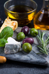 Tapas style cheese selection with olives,grapes and herbs