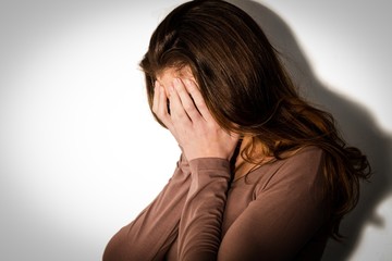 Depressed woman with head in hands