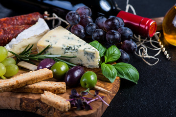 Tapas board with cheese,olives,grapes and red wine