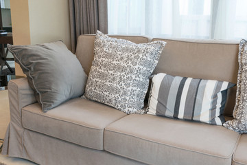 Sturdy brown tweed sofa with grey patterned pillows