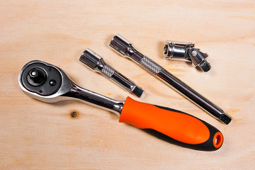 Metallic spanners on the wooden background