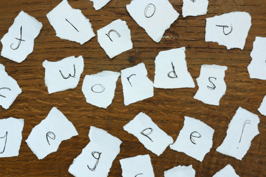 Torn letters against wood background