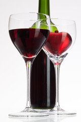 Wine glasses with red wine and heart