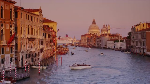 Wide shot of boats on Venetian canal / Venice, Italy