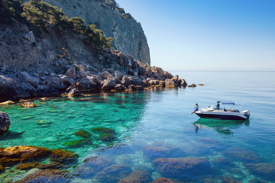 Recreation on the boat near the shore of a beautiful mountain.