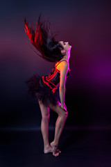 Burlesque performer in black and red corset